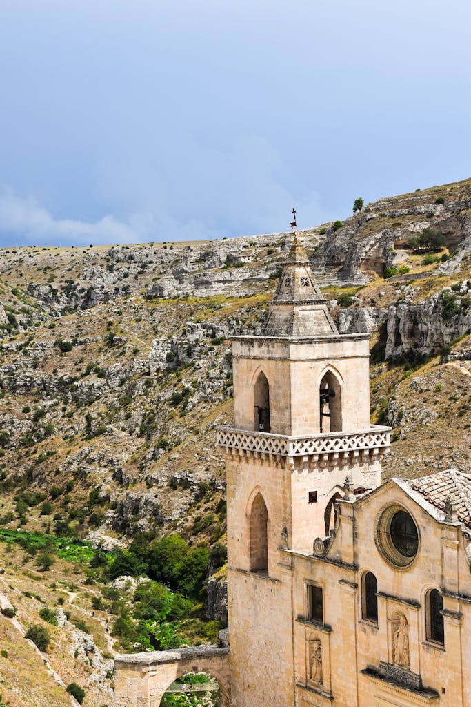Stunning view of ancient stone architecture in Matera, Italy, amidst rocky cliffs.